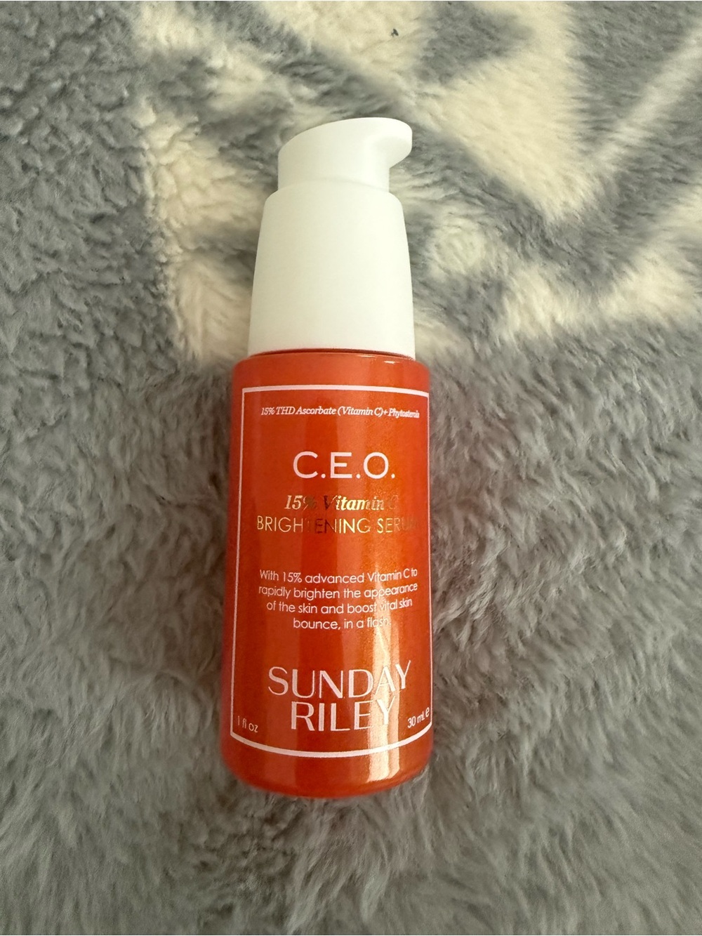 Sunday Riley C.E.O. Brightening Serum in orange and white pump